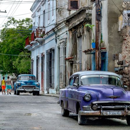 Side street of Cuban town near Havana with and classic cars.