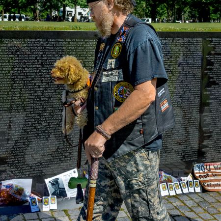 Vietnam Veteran and his dog at Memorial Wall in Washington D.C.