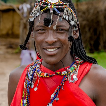 Maasai warrior in traditional dress and adornments.