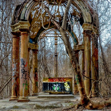 Abandoned Maryland church alter with metal cross, cupola and vines.