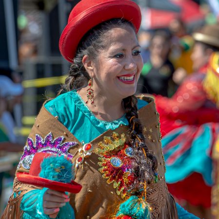 Pro Bolivian Festival portrait of women in traditional dress and red hat.