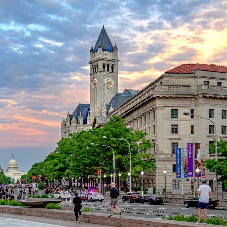 View down Pennsylvania Avenue with Capitol in background and Trump Hotel at sunset