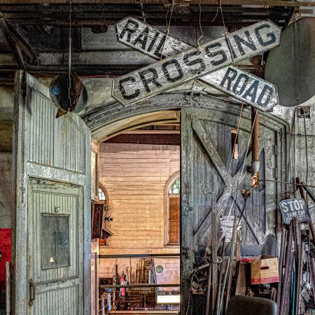 The entrance to a turn of the century pump house with transportation memorabilia accessories.