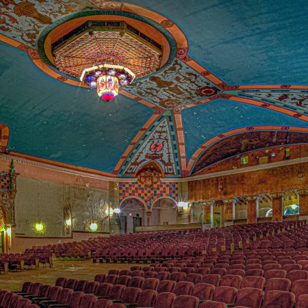 Abandoned Lansdowne Philadelphia theater with chandelier, seating and murals.