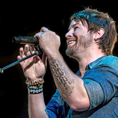 David Cook at microphone performing in concert for Declaration Tour.